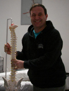 Alan Rankin holding replica of human spine